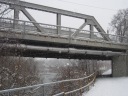Snowy walk on trail under bridge